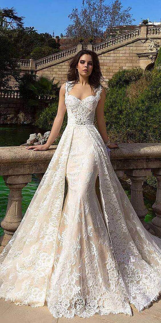47 perfect bridal gown ideas - find yours 30 Elegant bridal portrait featuring a champagne-nude wedding dress with ivory lace, set in a historic garden beside a reflecting pool.