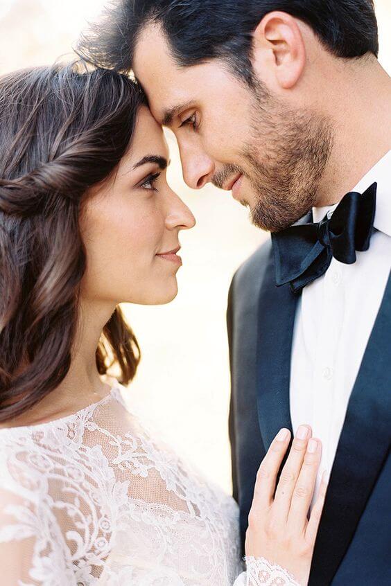 50 bride and groom photo ideas to save to posterity 12 Intimate bride and groom portrait, nose-to-nose in golden hour light. Bride in sheer lace gown, groom in black tuxedo, soft bokeh backdrop.