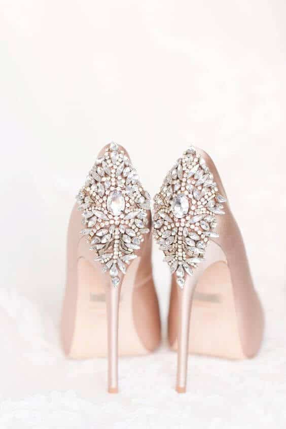 38 wedding accessories list - ideas to transform your big day into magic 13 Blush satin bridal heels with crystal and faux-pearl embellishments, set against a soft ivory background, perfect for wedding accessories.