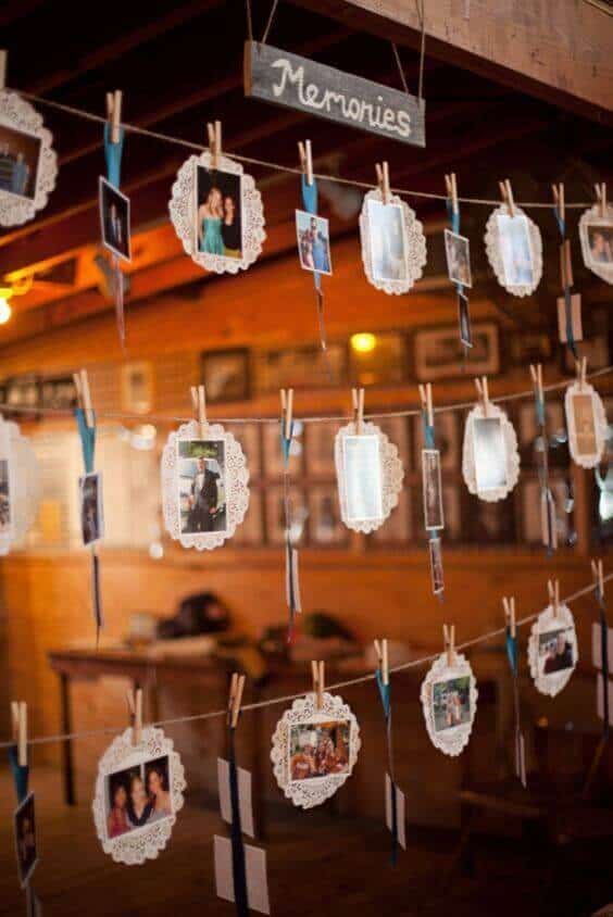 34 budget wedding ideas for a creative affordable wedding 31 Rustic barn wedding display featuring a 'memories' photo garland made of jute twine, clothespins, and doilies, creating a cozy, intimate atmosphere.