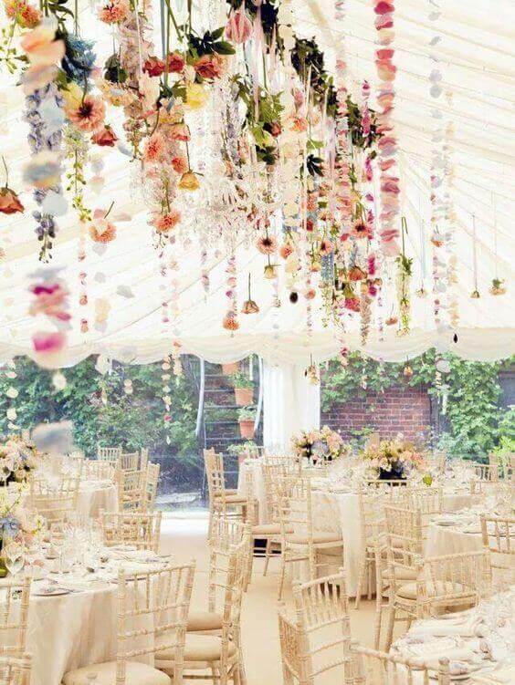 37 Morning Wedding Ideas filled with Sunshine color pallets 22 Light-filled marquee wedding reception featuring cascading floral installations, round tables with ivory linens, and Chiavari chairs.