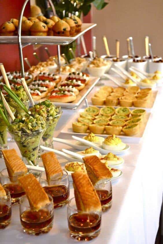 37 Morning Wedding Ideas filled with Sunshine color pallets 6 Upscale morning wedding buffet featuring tiered trays of mini muffins, bruschetta canapés, savory tartlets, avocado salad verrines, and amber drinks.