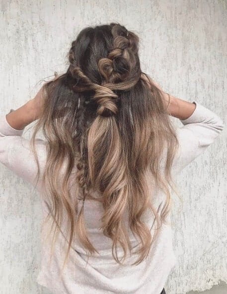 Back view of a boho half-up, half-down braided hairstyle with caramel-blonde balayage waves, perfect for cute wedding hairstyles.